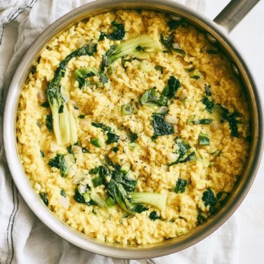 Bowl of anti-inflammatory creamy coconut rice garnished with fresh herbs.