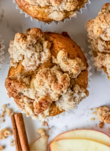 Freshly baked apple crumble muffins with a crispy crumble topping