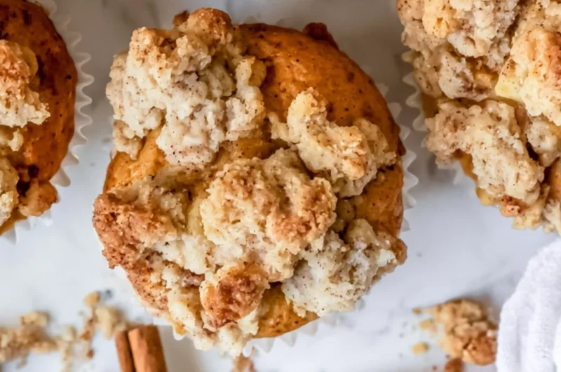 Freshly baked apple crumble muffins with a crispy crumble topping
