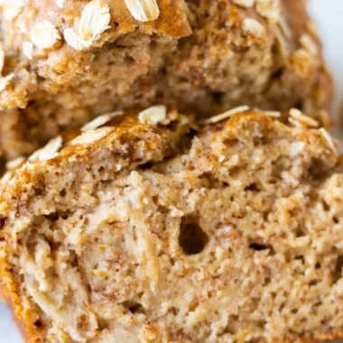 Slice of homemade banana oatmeal bread with oats and ripe bananas