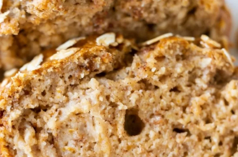 Slice of homemade banana oatmeal bread with oats and ripe bananas