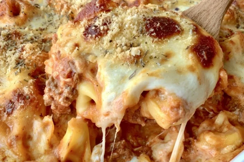 Cheesy baked tortellini casserole topped with meat sauce and melted cheese