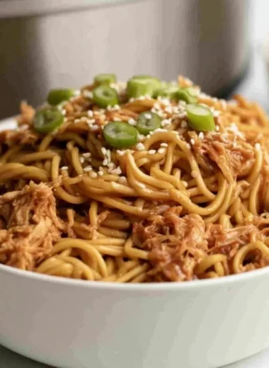 Crockpot Honey Garlic Chicken Noodles served in a bowl with chopsticks