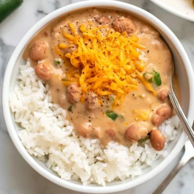 A bowl of easy homemade pinto beans with spices and herbs.