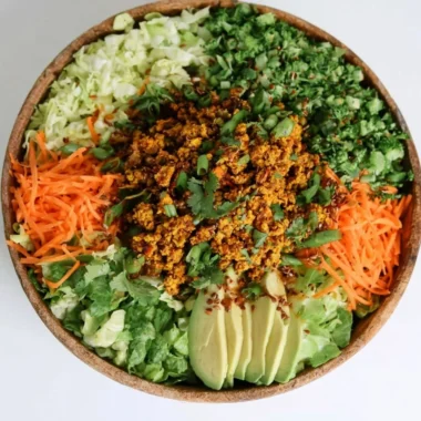 Delicious egg roll salad in a bowl with colorful vegetables and sesame dressing