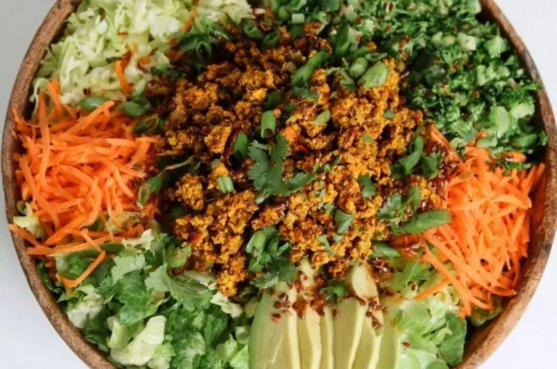 Delicious egg roll salad in a bowl with colorful vegetables and sesame dressing