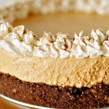No-Bake Pumpkin Silk Pie topped with whipped cream and a graham cracker crust