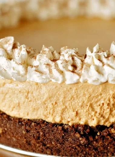 No-Bake Pumpkin Silk Pie topped with whipped cream and a graham cracker crust