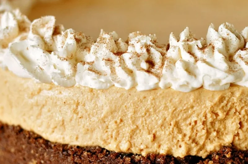 No-Bake Pumpkin Silk Pie topped with whipped cream and a graham cracker crust
