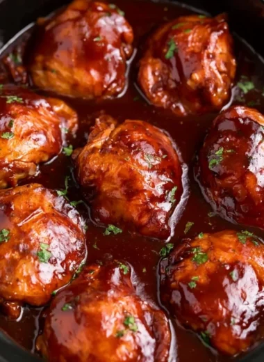 Delicious slow cooker BBQ chicken thighs served on a plate