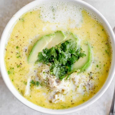 A bowl of creamy White Chicken Chili garnished with cilantro and jalapeños
