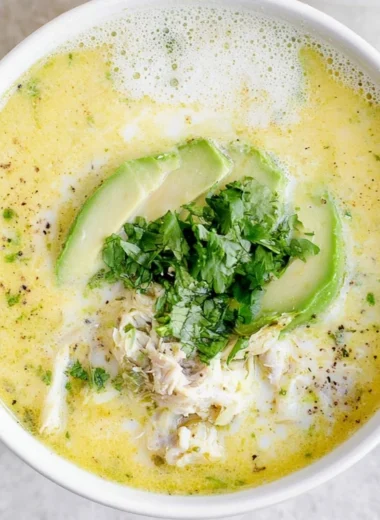 A bowl of creamy White Chicken Chili garnished with cilantro and jalapeños